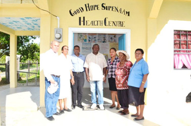 Maurice Bovell (centre) along with Public Health Minister, Dr George Norton (left) and other health care providers pose for a group photo after the handing over ceremony of the Good Hope, Supenaam Health Centre (GINA photo)