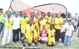 Victorious Grove Hi-Tech Captain Denzil Crawford collects the championship trophy from Marketing and Sales Manager of Continental Agencies Limited Avalon Jagnandan (third from right) while other members of the team and officials look on.