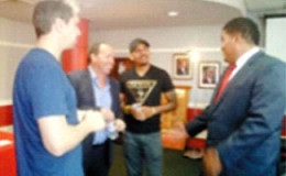 Minister of Sport and Youth Affairs Darryl Smith, right, has the attention of T&T and West Indies spinner Sunil Narine, second from right, Queen’s Park Cricket Club manager Jeffrey Guillen and bowling coach Carl Crowe.
