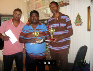 From left Khemraj Pooranmall, Jairam, president of the Guyana Draughts Association and Paul D’Anjou with their awards.
