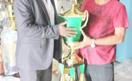 Trophy Stall’s Ramesh Sunich, right and one of the organisers of the event James Bond with the T20 trophy. Pix saved as Bond in sported