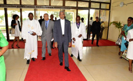 President David Granger (centre)  being escorted into the National Cultural Centre by Bishop Otto Wade and Rev. Kofia Nials  (Ministry of the Presidency photo)
