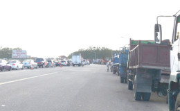The trucks awaiting their turn to cross the bridge
