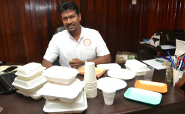 Rajkumar Outar and a sampling of food and beverage containers
