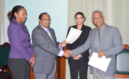 Prime Minister Moses Nagamootoo (second from left) receiving the Guyana Bar Association's Report from its President Christopher Ram. (GINA photo)