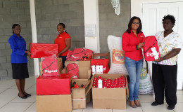 Digicel’s Senior Sponsorship Executive Louanna Abrams (second from left) and Communications Manager Vidya Sanichara (second from right) handing over a quantity of school and other items to Pearline Cummings and Ms. Pam of the Mahaica Children’s Home.