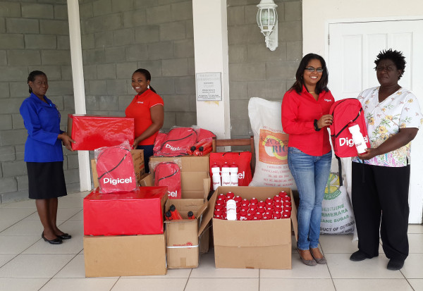 Digicel’s Senior Sponsorship Executive Louanna Abrams (second from left) and Communications Manager Vidya Sanichara (second from right) handing over a quantity of school and other items to Pearline Cummings and Ms. Pam of the Mahaica Children’s Home.