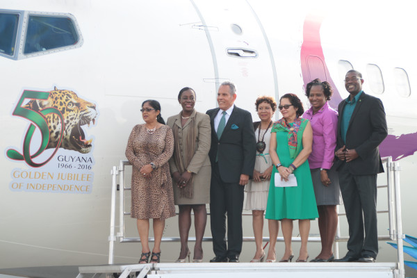 First Lady Sandra Granger (third from right), Sita Nagamootoo (left) and CAL Chairman Philip Marshall stand on a platform next to the logo with government ministers. (Ministry of the Presidency photo)