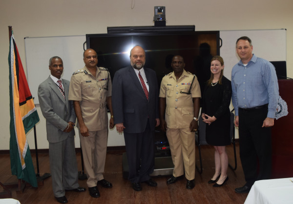 From left to right  are U.S. Embassy INL Coordinator Leon Carr III, Guyana Police Force Commissioner Seelall Persaud, U.S. Ambassador Perry L. Holloway, Guyana Police Force Training Officer Paul Williams, MetroStar Systems Program Managers Christine Allgood, and Shai Segall.