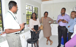 Minister within the Ministry of Public Health, Dr. Karen Cummings (second from left) along with her team interacting with the staff at Wakenaam hospital (GINA photo)