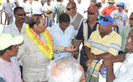 Prime Minister Moses Nagamootoo (with garland) engaging farmers after the commissioning of the Lima pump station (GINA photo)