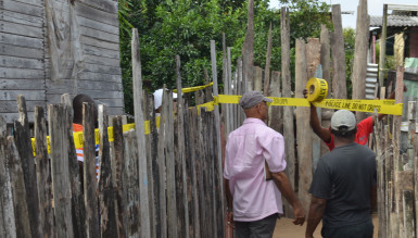 Police officers cordoning off the crime scene yesterday morning