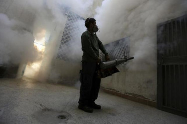 A municipal worker fumigates inside a building to help control the spread of the mosquito-borne Zika virus in Caracas, February 2, 2016. REUTERS/Marco Bello 
