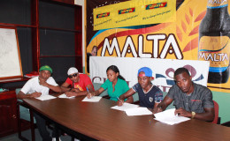 It is official! (From left) Dexter ‘De Kid’ Marques, Imran ‘Magic’ Khan, Ansilla Norville, Mandessa Moses and Quincy Gomes affixing signatures to their respective contracts yesterday. 