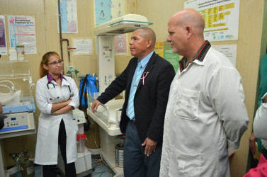  Minister of Public Health Dr George Norton (at centre) listens to a doctor inside the refurbished Neonatal Intensive Care Unit at the West Demerara Regional Hospital. (Government Information Agency photo)