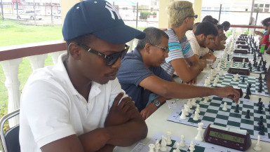 A section of the participants at the Trophy Stall chess tournament. From left: Playing the number one board is Wendell Meusa, followed by Loris Nathoo on board number two and Rashad Hussein. The photograph was taken on the patio of the National Racquet Centre on Woolford Avenue. Each January, Trophy Stall owner Ramesh Sunich sponsors a chess tournament in the name of his business on behalf of the Guyana Chess Federation.