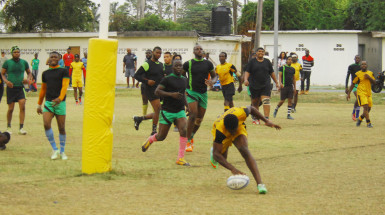 O’Neil Charles’ second try is greeted by frowns from the UG Wolfpack. Charles helped the Caribs to defeat the Wolves 31-25 yesterday at the National Park. (Orlando Charles photo)