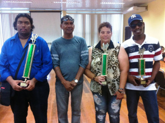 Owner of the Trophy Stall Ramesh Sunich (second, left), is photographed with the winner of the Trophy Stall Chess Tournament Taffin Khan on his right, Maria Thomas and Wendell Meusa. Thomas and Meusa were the second and third place finishers. Thomas is a naturalized Guyanese originally from Cuba. She represented Guyana at the 2014 Tromso Chess Olympiad.