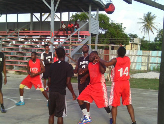 Action between Canje Knights and Fyrish Black Sharks during their matchup in the Anamayah Memorial Basketball Championship at the Fyrish Basketball Court Sunday. 