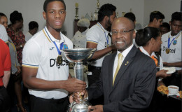 Shimron Hetmyer  and Minister Stephen Lashley show off the World Cup trophy during the West Indies Under-19s arrival at the Grantley Adams International Airport in Barbados on Tuesday. WICB Media Photo/Randy Brooks
