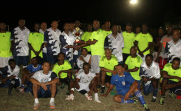  Members of the Georgetown (GT) All-Stars and Georgetown Football Club (GFC) Masters team pose with the Peter Lashley Memorial trophy following the conclusion of the match at the GFC ground, Bourda, Sunday.
