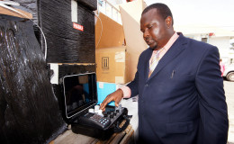 Administrator of the Mining School, John Applewhite looks at some of the equipment. (Ministry of the Presidency photo)
