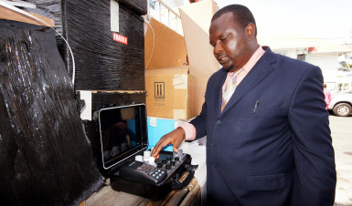 Administrator of the Mining School, John Applewhite looks at some of the equipment. (Ministry of the Presidency photo)