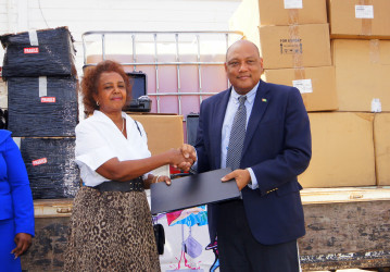 United Nations Resident Coordinator, Khadija Musa (left) handing over the equipment to Minister of Natural Resources, Raphael Trotman (Ministry of the Presidency photo)    