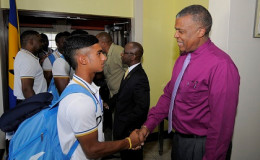Trinidadian Kirstan Kallicharan is greeted by West Indies Cricket Board chief executive, Michael Muirhead, on the team’s return to the region on Tuesday. (Photo courtesy WICB Media) 
