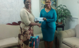 Minister Nicolette Henry (left) receives the cheque from Republic Bank’s Water Street Branch Manager Celine Davis.