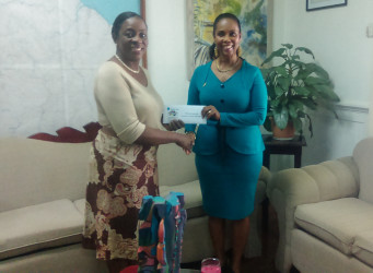 Minister Nicolette Henry (left) receives the cheque from Republic Bank’s Water Street Branch Manager Celine Davis.