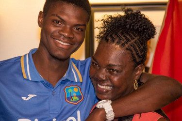 Fast bowler Alzarri Joseph flashes a rare smile as he is embraced on arrival by his mother, Sharon. 