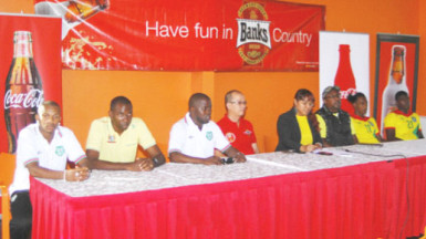 Members of the Golden Jaguars and Suriname International match launch party from left to right-Suriname Captain Albert Nibte, Suriname Head-coach Werner Blackson, Team Manager Humphrey Dundas, Banks Beer Brand Manager Brian Cho-Hen, GFF PRO Debra Francis, Guyana Head-coach Jamaal Shabazz, Golden Jaguars Captain Gregory Richardson and Golden Jaguars’ Colin Nelson pose for a photo opportunity following the official launch yesterday at the Pegasus Hotel. (Orlando Charles photo) 