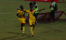 Golden Jaguars scorer Gregory Richardson (right) celebrating with team mate Joshua Browne after opening the scoring against Suriname in their International Friendly at the National Stadium in Providence. (Orlando Charles photo)
