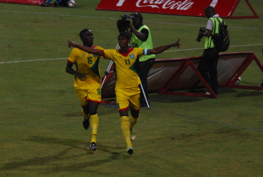 Golden Jaguars scorer Gregory Richardson (right) celebrating with team mate Joshua Browne after opening the scoring against Suriname in their International Friendly at the National Stadium in Providence. (Orlando Charles photo) 