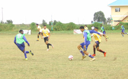 Action between South Ruimveldt in green and School of the Nations in yellow in the 4th Annual Milo Secondary Schools Football Championship at the Ministry of Education ground
