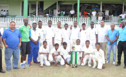The victorious Demerara U15 team pose with GCB President Drubahadur along with coach Clive Grimmond and others.