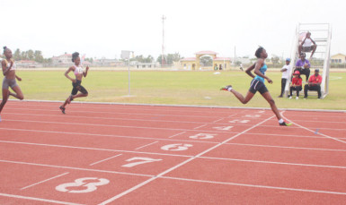 Kenisha Phillips powering across the line in the under-18 100m event on Saturday. 
