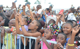 Wonderment: Part of the enthusiastic crowd at the flag raising yesterday at D’Urban Park (Keno George photo)