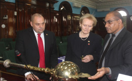 Etwaroo Jagernath (right), Assistant Sergeant-At-Arms, explaining the significance of the Parliamentary Mace to two of the visitors