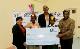 Marketing Manager Anjanie Hackett (left) presenting the cheque