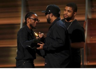 Kendrick Lamar (L) takes the stage to accept the award for Best Rap Album for "To Pimp A Butterfly" from presenters Ice Cube and O'Shea Jackson Jr. at the 58th Grammy Awards in Los Angeles, California February 15, 2016. REUTERS/Mario Anzuoni