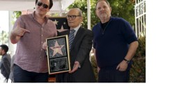 Italian composer Ennio Morricone (C) poses on his star with director Quentin Tarantino (L) and producer Harvey Weinstein after it was unveiled on the Hollywood Walk of Fame in Hollywood, California February 26, 2016.
Reuters/Mario Anzuoni
