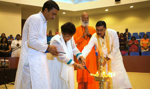 Minister of Social Cohesion, Amna Ally (second from left), Executive Member of the Viraat Sabhaa Guyana, Pandit Haresh Tewari, (left) Swamiji Kaivalyananda Saraswati (third from left) and President of the Viraat Sabhaa, Pandit Rabindranath Persaud, participate in the lighting of a ceremonial lamp. (Ministry of the Presidency photo)