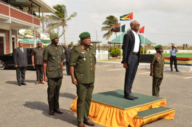 Commander-in-Chief of the Armed Forces, President David Granger (on the dais) GDF Chief of Staff, Brigadier General Mark Phillips (left) and Colonel George Lewis (right)  take the salute as the Guyana Defence Force ranks march past. (Ministry of the Presidency photo) 