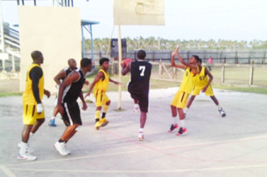 Action between Fyrish Black Sharks in black and Rose Hall Town Jammers in yellow during their matchup in the BABA sanctioned Anamayah Memorial Basketball Championship at the Ithaca Basketball Court Sunday. 