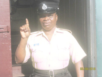 A policewoman showing her inked finger after voting at the New Amsterdam Town Hall yesterday. 