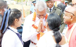 President David Granger offering a traditional greeting after being garlanded on arrival at the Cove and John Ashram on Monday for the annual Shivratri (Night of Shiva) observances. (Keno George photo)