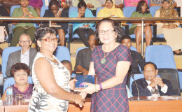 Nandranie Coonjah (left), Deputy Chairman of Region Two receiving an award from First Lady, Sandra Granger for her work in the area of community development. Coonjah was among a number of women receiving awards. (Ministry of the Presidency photo)