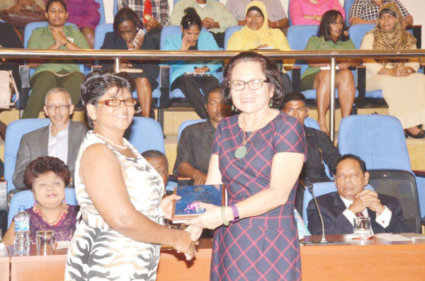 Nandranie Coonjah (left), Deputy Chairman of Region Two receiving an award from First Lady, Sandra Granger for her work in the area of community development. Coonjah was among a number of women receiving awards. (Ministry of the Presidency photo)